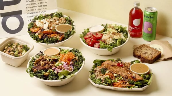 Individual atis salad bowls and protein plates with drinks on a table